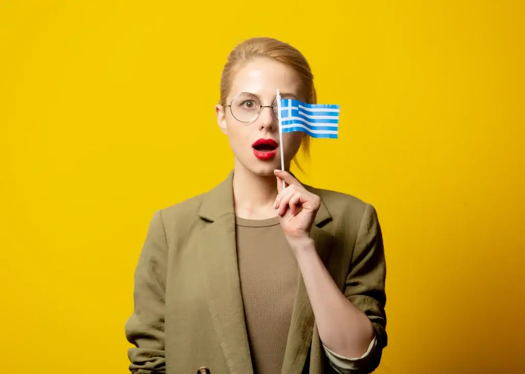 A woman holding a Greek Flag.